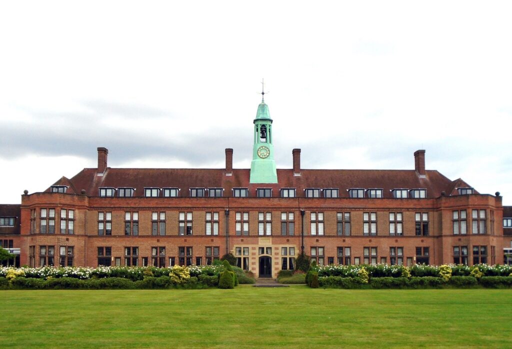 A red-brick university building with a clock tower, Britain