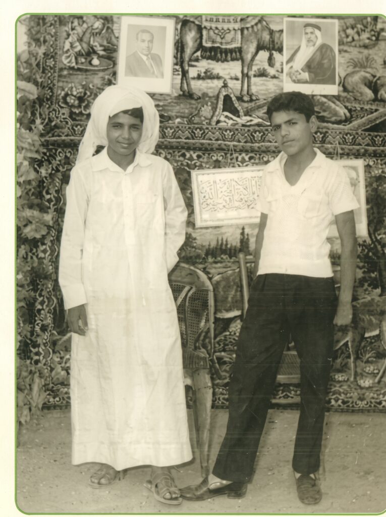 Abdul Rahman Al-Sumait as a boy in dishdasha and ghutra with a friend