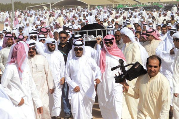 The bier of Dr Abdul Rahman Al-Sumait carried through the crowd at Sulaibikhat